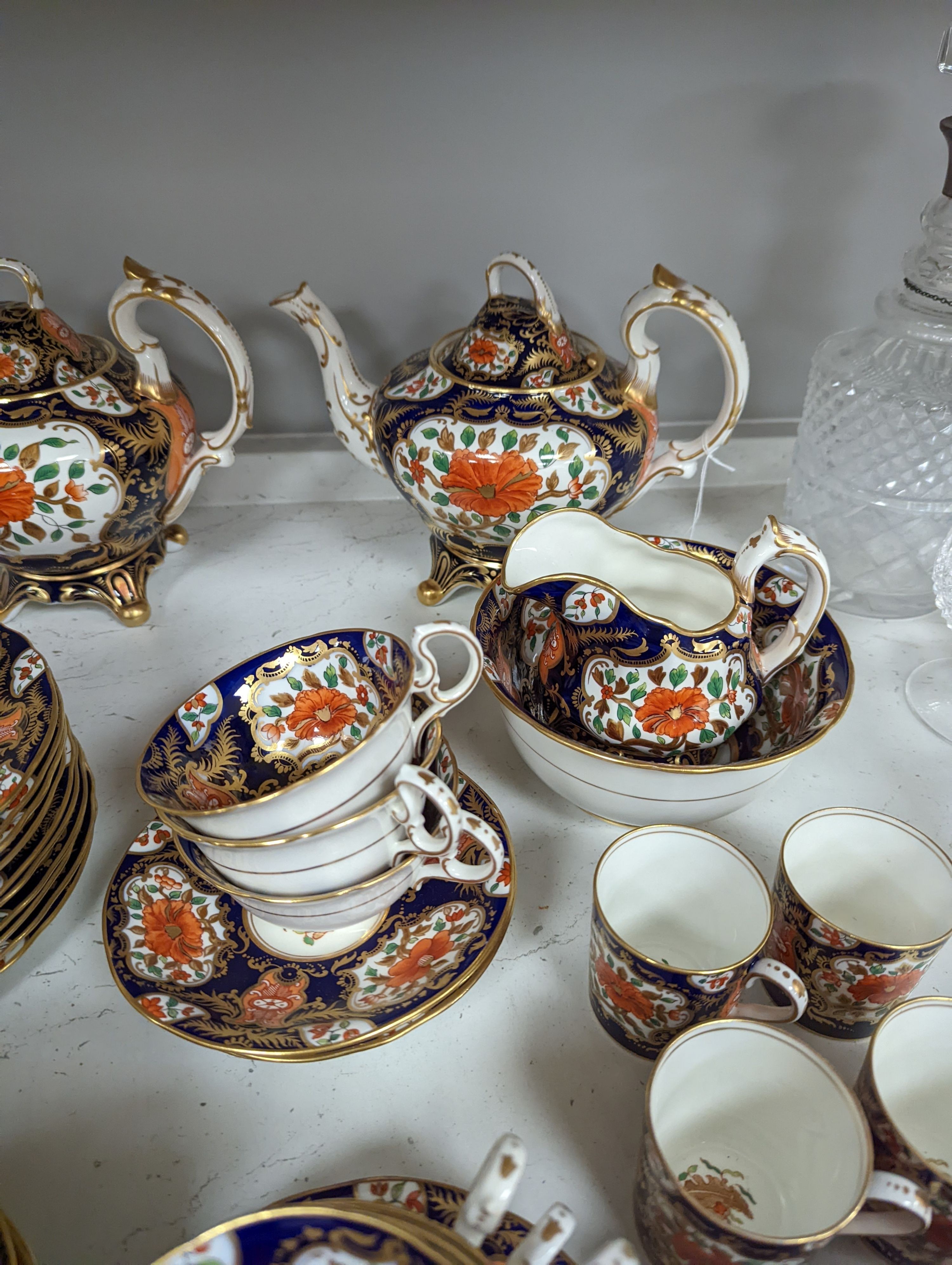 A mid 19th century English bone china fifty-two piece part tea and coffee service, decorated in an Imari pattern